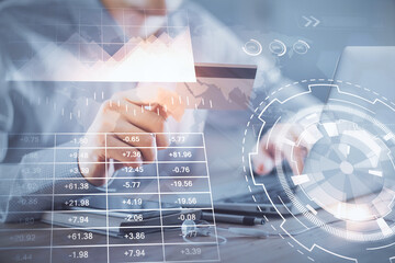 Double exposure of man hands holding a credit card and Forex graph drawing. Stock trading and digital fintech in Internet E-commerce concept.