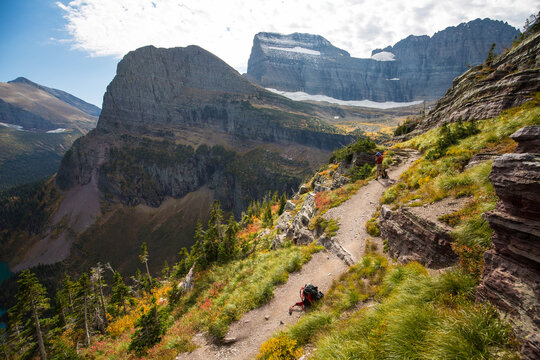 Hiker taking photo along trail to Grinnell Lake in Glacier National Park