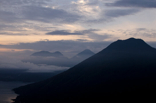 Silhouetted mountains and Lake Atitlan during sunrise