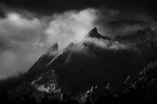 View of Boulder Flatirons against cloudy sky