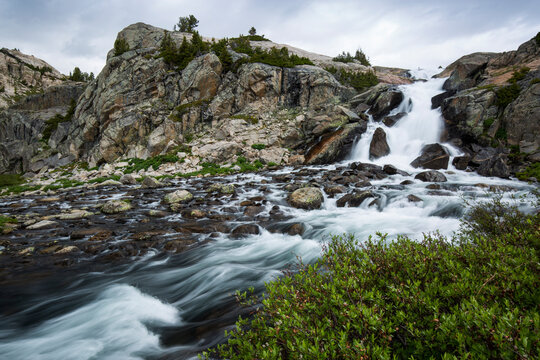 View of waterfall against cloudy sky