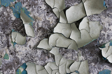 Peeling paint on the wall. Old concrete wall with cracked flaking paint. Weathered rough painted...