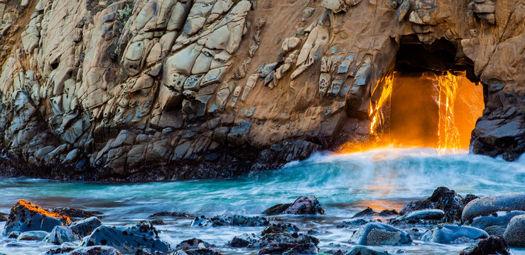 Sunlight through Keyhole Arch at Pfeiffer Beach during sunset