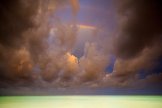 View of stormy clouds and rainbow over Caribbean Ocean