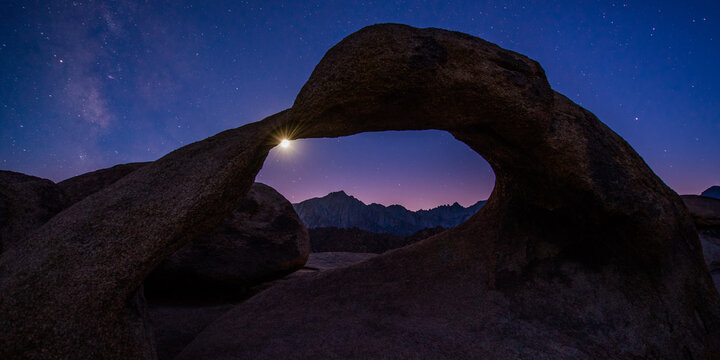 Moon seen through Mobius Arch against starry sky at night
