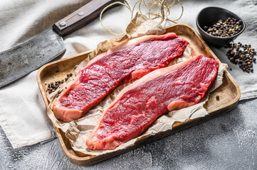 Fresh raw marbled beef steak. Gray background. Top view