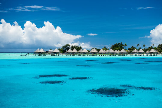 Scenic view of stilt bungalow in sea