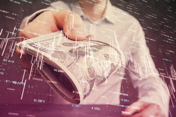 Multi exposure of financial graph drawing hologram and USA dollars bills and man hands. Analysis concept.