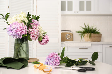 Bouquet of beautiful hydrangea flowers on white table indoors. Interior design