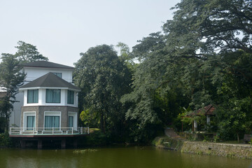 Fototapeta na wymiar Ninoy Aquino parks and wildlife water lagoon plus house facade in Quezon City, Philippines