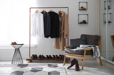 Dressing room interior with clothing rack and armchair