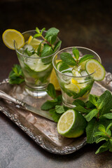 Glass of mojito, lime and mint martini on a vintage tray. Vintage retro style.
