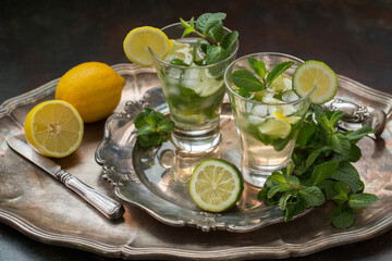 Glass of mojito, lime and mint martini on a vintage tray. Vintage retro style.