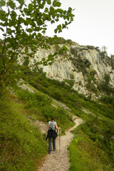 young woman hiking in mountain forest