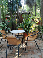 Fototapeta na wymiar Outdoor furniture, rattan chairs and a table on the terrace in the garden.