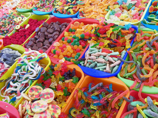Traditional sweets: cookies, jelly, candy, chocolate, marshmallow, nuts and more  during catholic Corpus Christi celebration in numerous stands at open market in Cuenca, Ecuador
