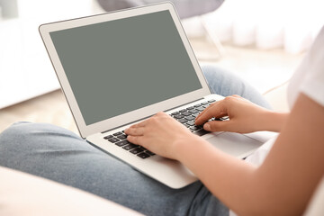 Woman working with modern laptop indoors, closeup. Space for design