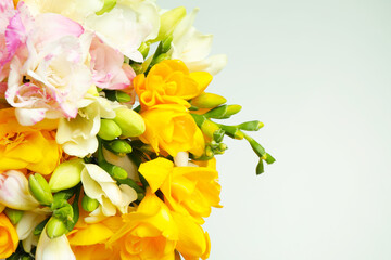 Beautiful colorful freesia bouquet on grey background, closeup