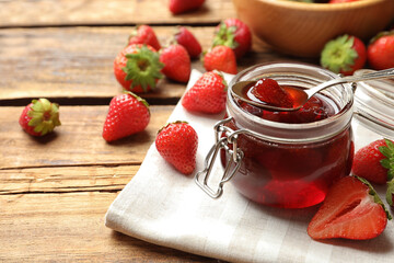 Delicious pickled strawberry jam and fresh berries on wooden table