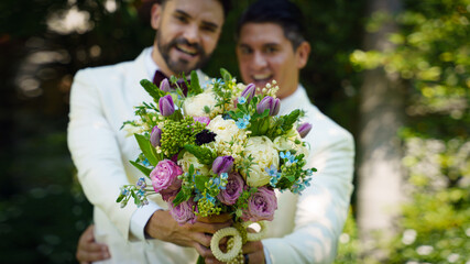 lgbt gay bride and groom with flower bouquet in wedding ceremony