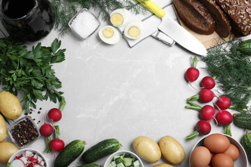 Frame of kvass and other okroshka ingredients on light grey table, flat lay with space for text. Traditional Russian summer soup