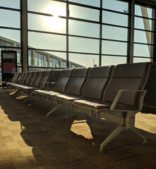 seats in the airport lounge under morning sunlight