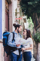 Latin people and tourists reading a map in America Colonial city