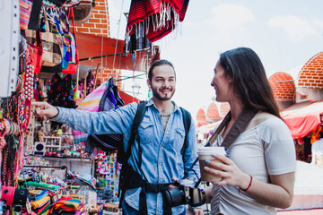 Latin couple backpacker shopping in a Tourist Market in Mexico City, Mexican Traveler in Latin America