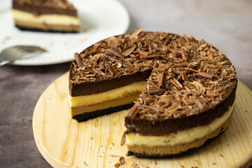 Homemade triple layers chocolate bake cheesecake in round shape
