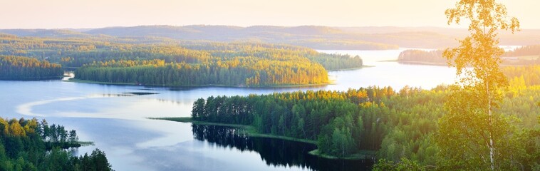 Clear blue Saimaa lake at sunset, Finland, aerial view. Picturesque panoramic scenery. Atmospheric landscape. Pure nature, ecology, environmental conservation, eco tourism, travel destinations