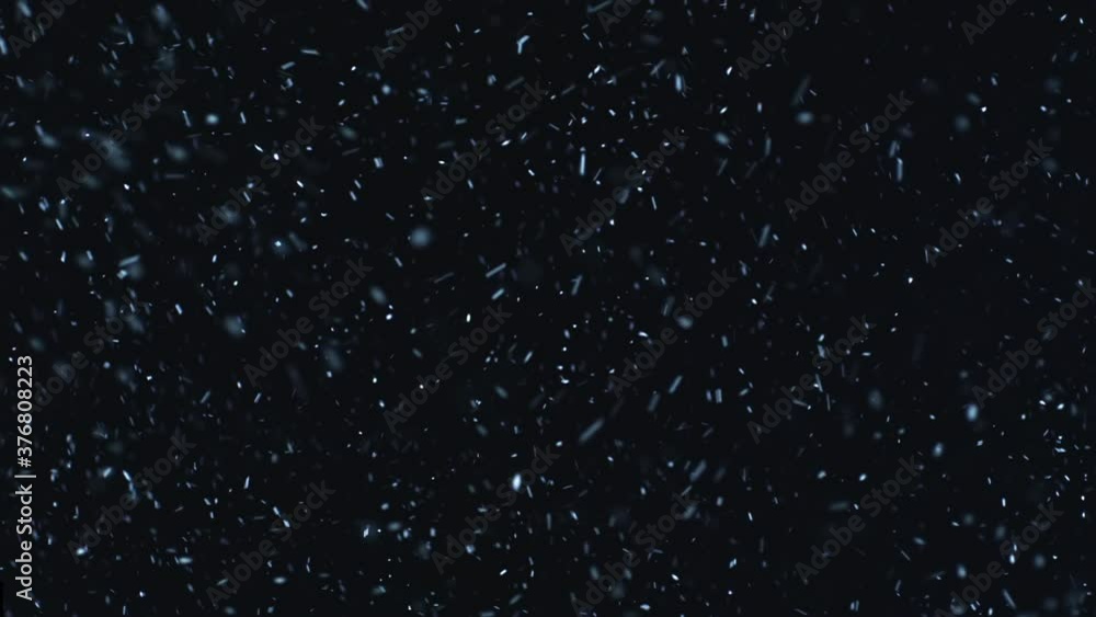 Poster 30+ seconds of snowstorm against black screen loopable in slow-motion. christmas vfx insert element.