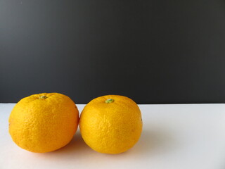 白背景に二つ並んだ冬の果物、柚子