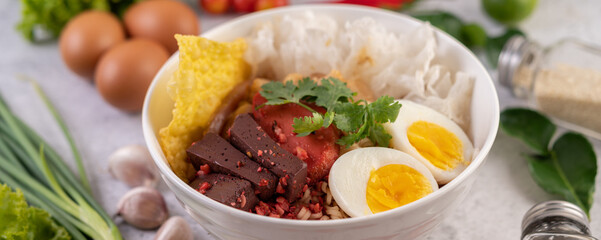 Yentafo with boiled egg, spring onion, chili, lime and garlic.