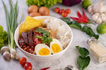 Yentafo with boiled egg, spring onion, chili, lime and garlic.