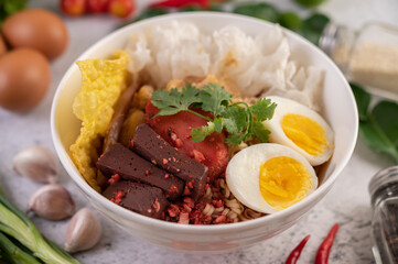 Yentafo with boiled egg, spring onion, chili, lime and garlic.