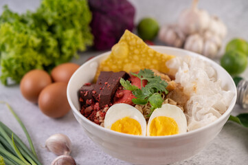 Yentafo with boiled egg, spring onion, chili, lime and garlic.