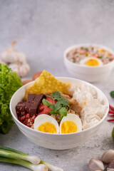 Yentafo with boiled egg, spring onion, chili, lime and garlic.