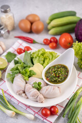 Squid stuffed with cooked pork with seafood sauce.