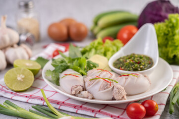 Squid stuffed with cooked pork with seafood sauce.