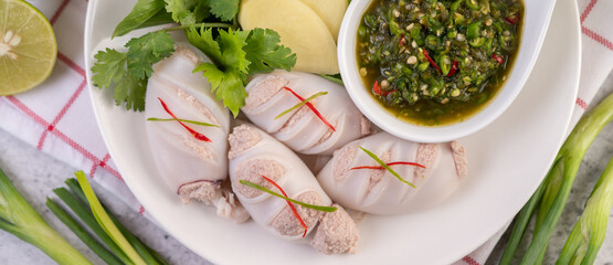 Squid stuffed with cooked pork with seafood sauce.