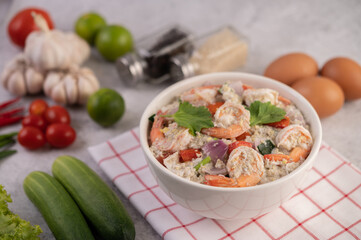 Shrimp Salad with Tomato Red onion and coriander in a white cup.