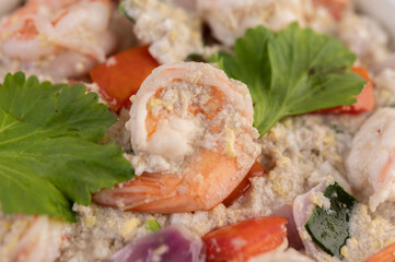 Shrimp Salad with Tomato Red onion and coriander in a white cup.