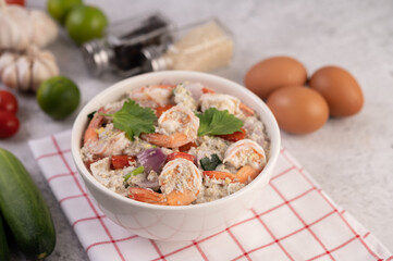 Shrimp Salad with Tomato Red onion and coriander in a white cup.