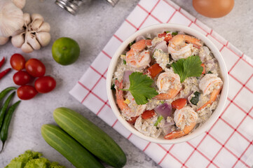 Shrimp Salad with Tomato Red onion and coriander in a white cup.