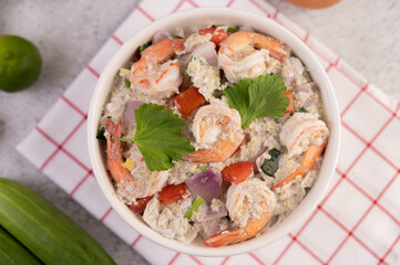 Shrimp Salad with Tomato Red onion and coriander in a white cup.