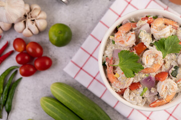 Shrimp Salad with Tomato Red onion and coriander in a white cup.