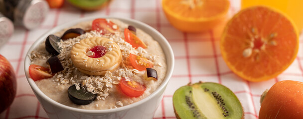 Dessert cup with apples, kiwi, orange, and grapes.