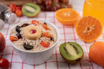 Dessert cup with apples, kiwi, orange, and grapes.
