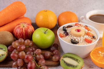 Dessert cup with apples, kiwi, orange, and grapes.