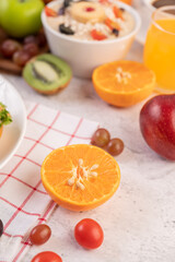 Orange cut in half with grapes and orange juice.